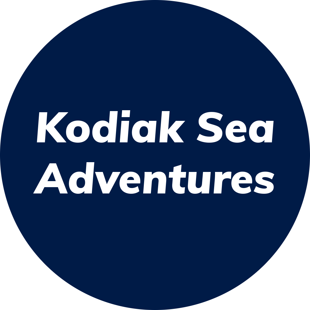 White text reading Kodiak Sea Adventures in bold font is centered on a dark blue circular background, evoking the spirit of adventure found in Kodiak.