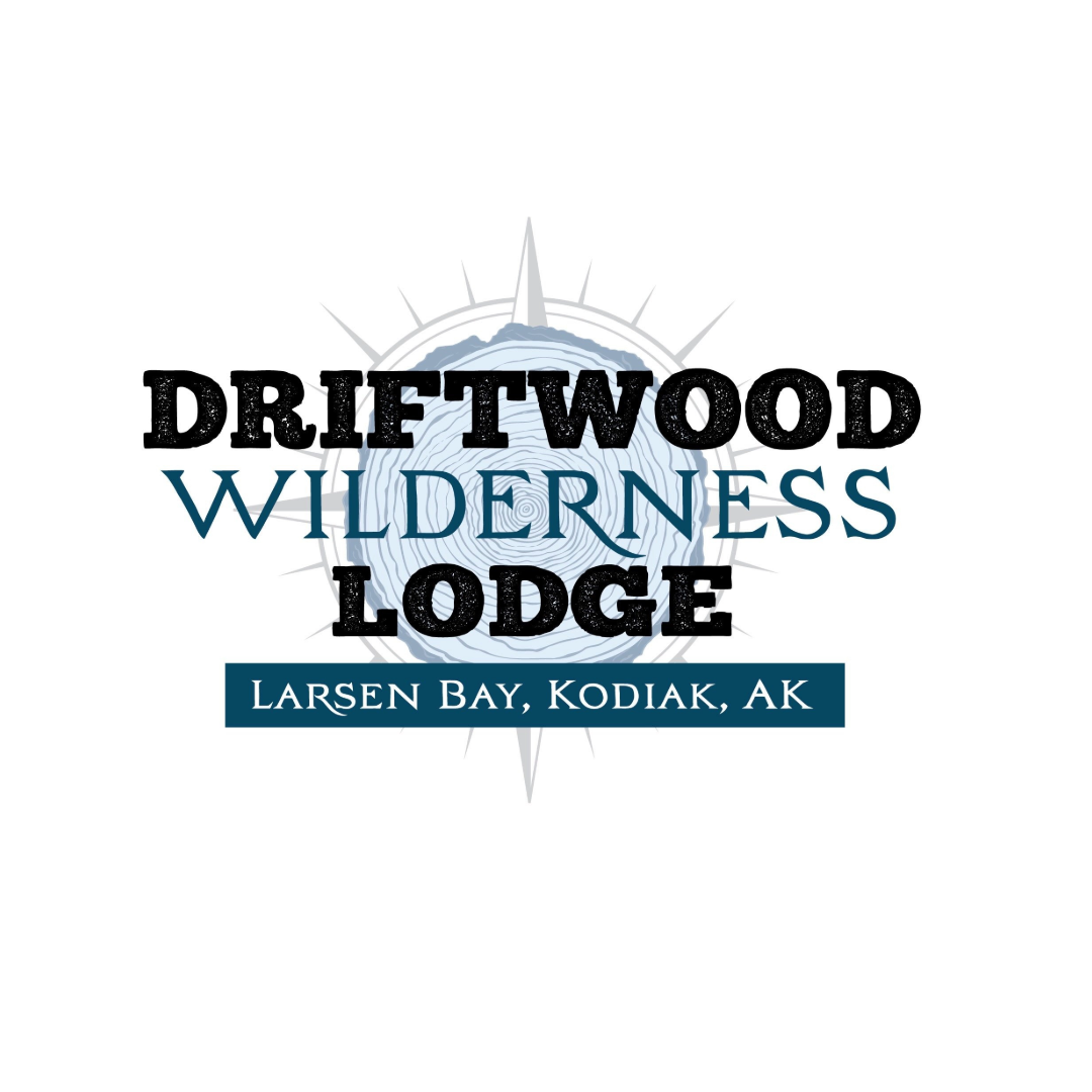 Logo for Driftwood Wilderness Lodge featuring "Driftwood Wilderness Lodge" and "Larsen Bay, Kodiak, AK" over a blue compass design that captures the spirit of Kodiak’s wild beauty.