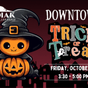 A Halloween event poster features a cute pumpkin character in a witch hat holding a jack-o-lantern. Text reads Kodiak Chamber of Commerce Downtown Trick or Treat, Friday, October 31, 3:30 - 5:00 PM. Kodiak houses are silhouetted in the background.