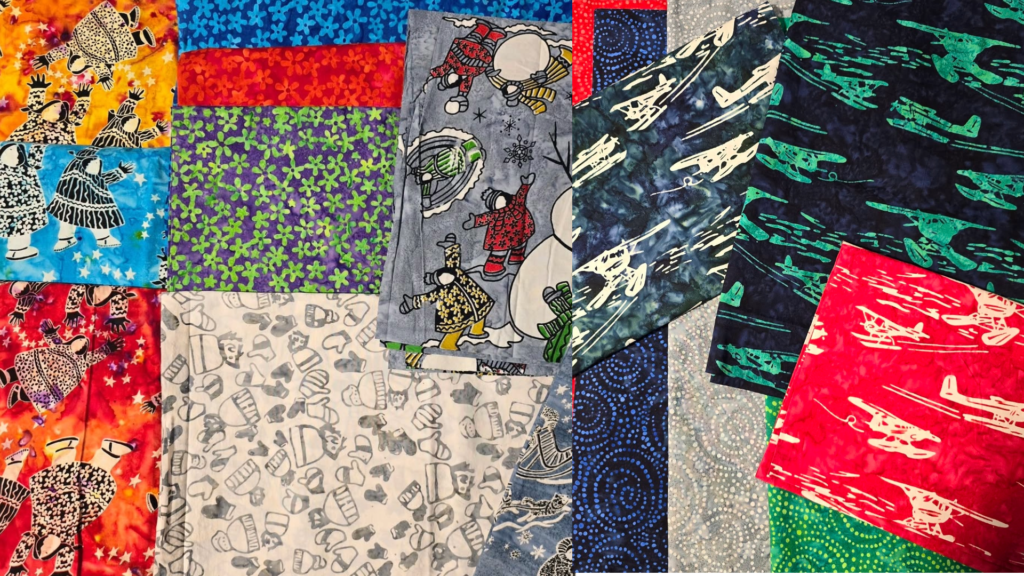A variety of colorful fabric squares with different patterns, from abstract designs to airplanes and animals, are laid out flat and overlapping each other—perfect inspiration from a fabric shop in Kodiak.