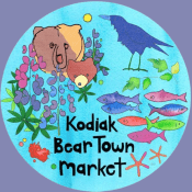 A colorful circular logo with a bear and cub, a blue bird, fish, starfish, flowers, and plants, with the text Kodiak Bear Town Market in black on a blue background.