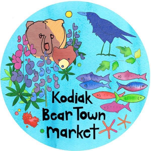 A round logo with a bear, a bear cub, a purple crow, lupine flowers, colorful fish, a crab, starfish, and text reading Kodiak Bear Town Market on a blue background.